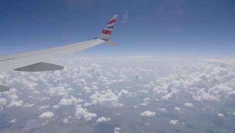 Plane-over-clouds-wing-view-from-the-window-cumulonimbus